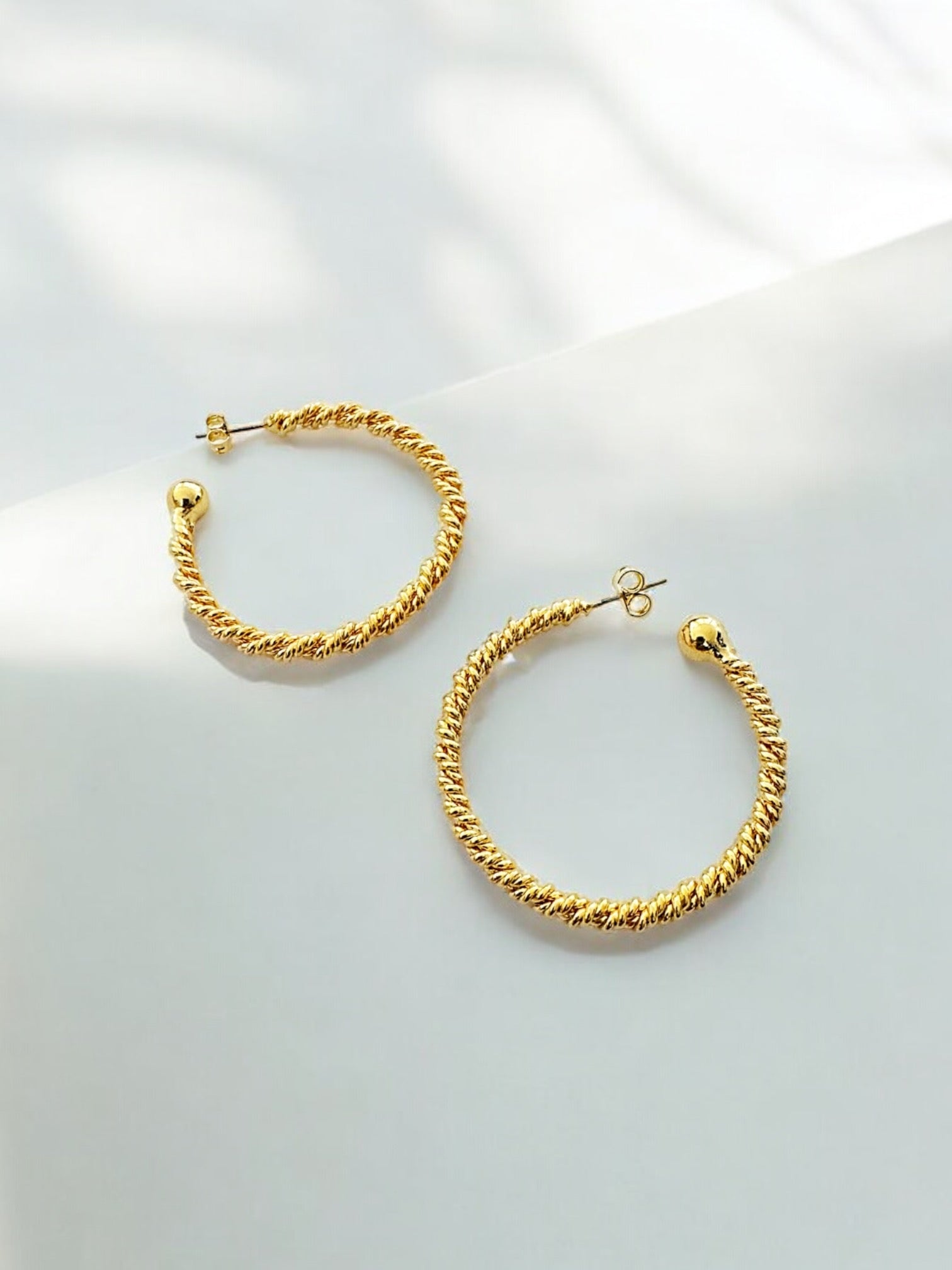 Rebecca Twist hoop earring
